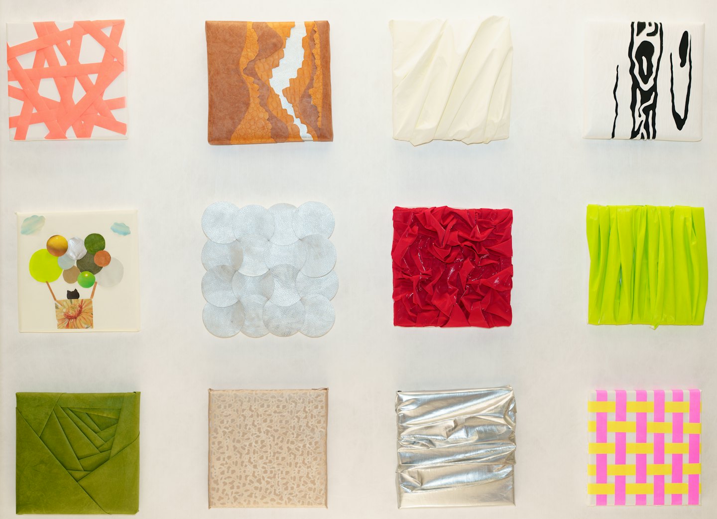 Twelve colorful abstract art pieces arranged in a grid on a wall.